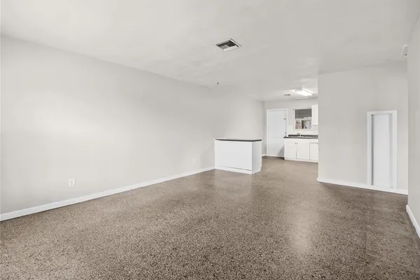 a view of a big room with closet and white walls
