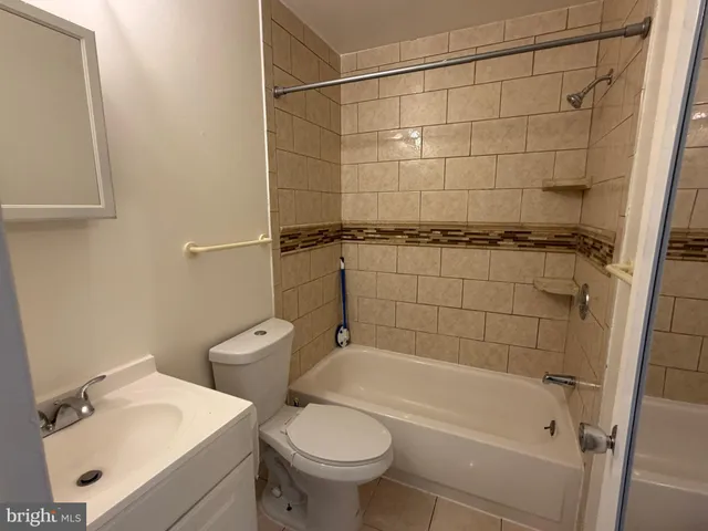 a bathroom with a shower a toilet and sink