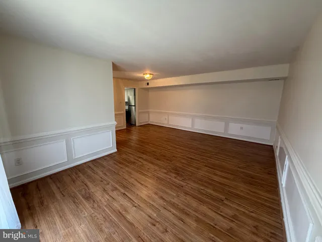 a view of an empty room and wooden floor