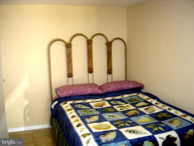604 Charing Cross Road Baltimore, MD 21229 - Photo 11 of 13 a bedroom with bed and a mirror
