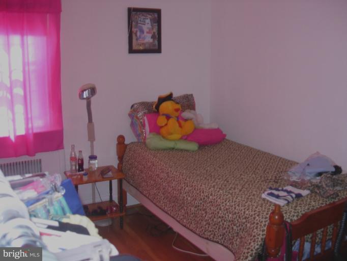 604 Charing Cross Road Baltimore, MD 21229 - Photo 3 of 13 a bedroom with a bed and a dresser