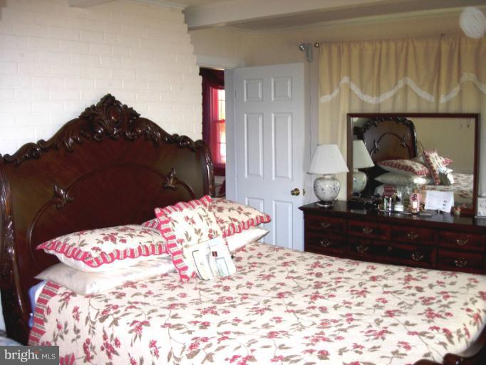 604 Charing Cross Road Baltimore, MD 21229 - Photo 5 of 13 a bedroom with a bed and a dresser