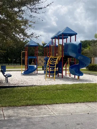 a view of a park with swings and slides