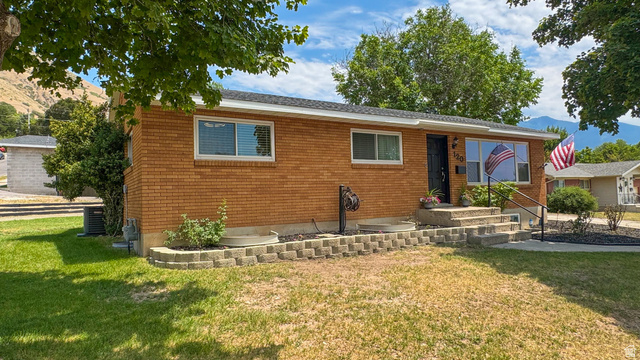 120 North 1230 E Street Springville, UT 84663 - Photo 4 of 60 Brick exterior with a dark entry door and white trim windows