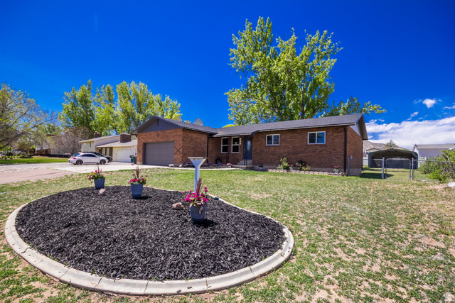 634 South 2100th Street West Vernal, UT 84078 - Photo 55 of 71 Brick exterior home with a dark shingle roof and an attached garage