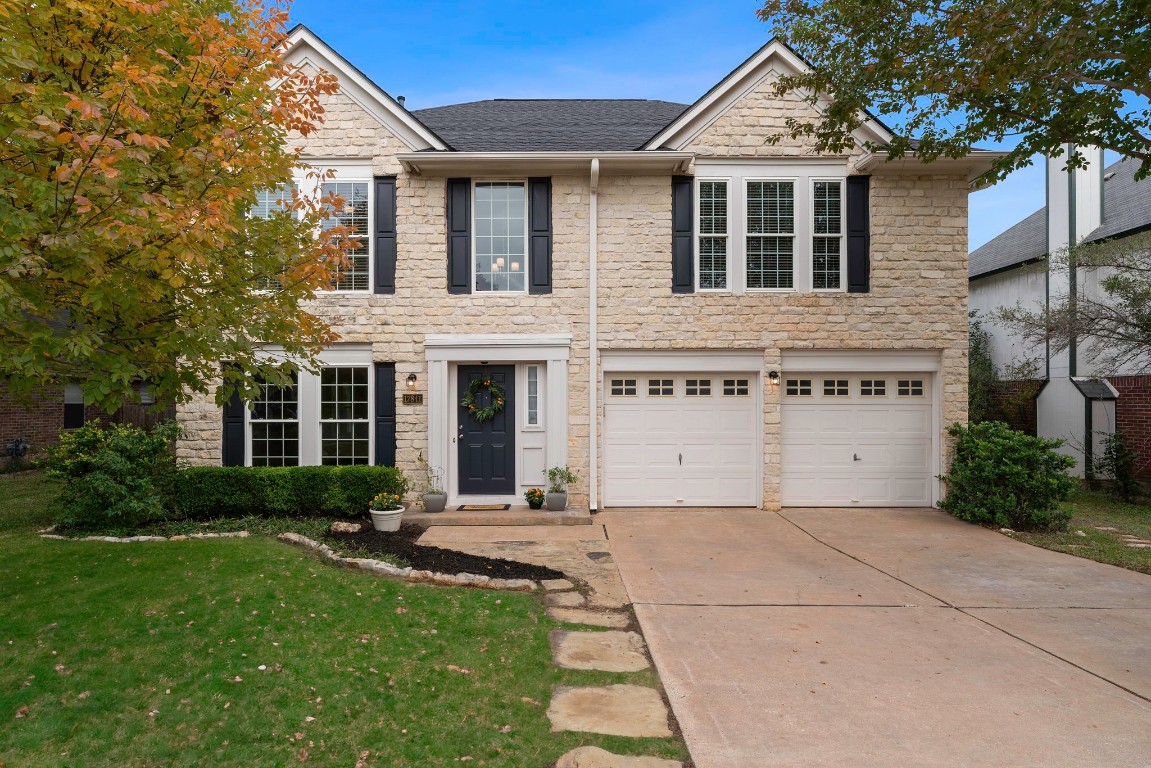 a front view of a house with a yard and outdoor seating