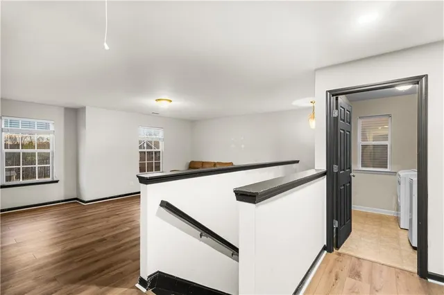 a view of a kitchen with a sink wooden floor and a window