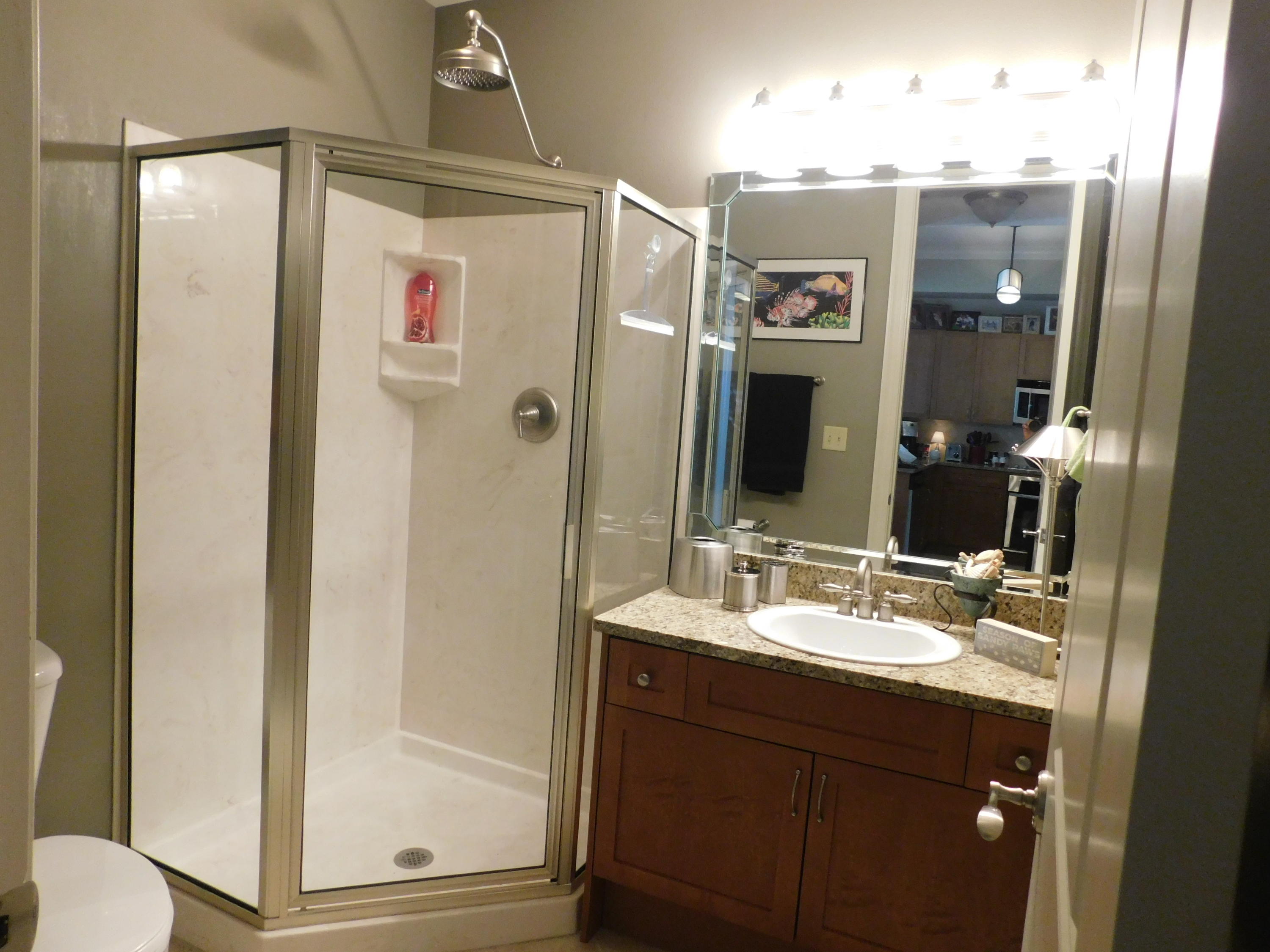 4368 West County Highway 30A, Unit 401 Santa Rosa Beach, FL 32459 - Photo 12 of 22 a bathroom with a shower sink and mirror