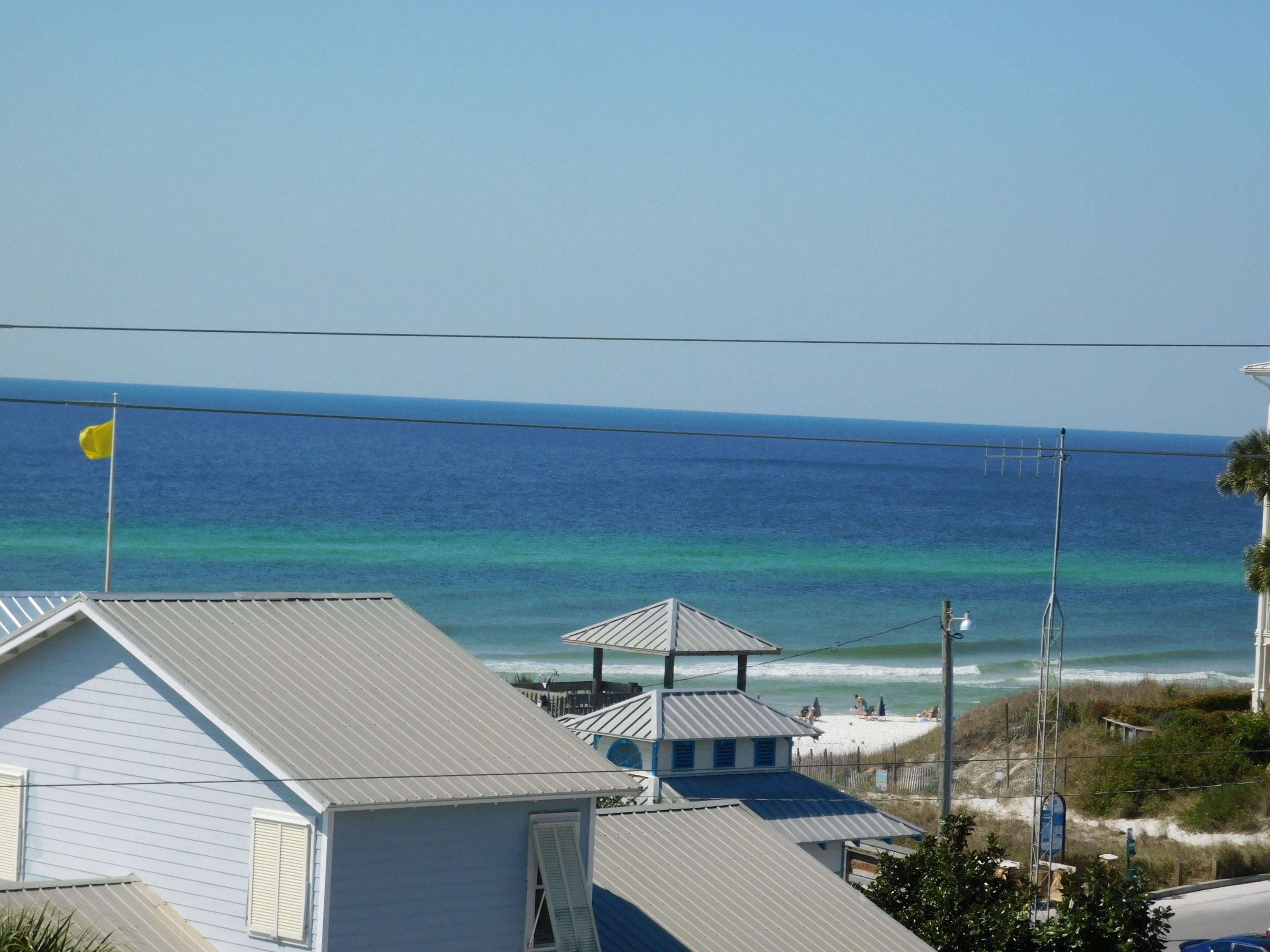 4368 West County Highway 30A, Unit 401 Santa Rosa Beach, FL 32459 - Photo 4 of 22 a backyard of a house with table and chairs
