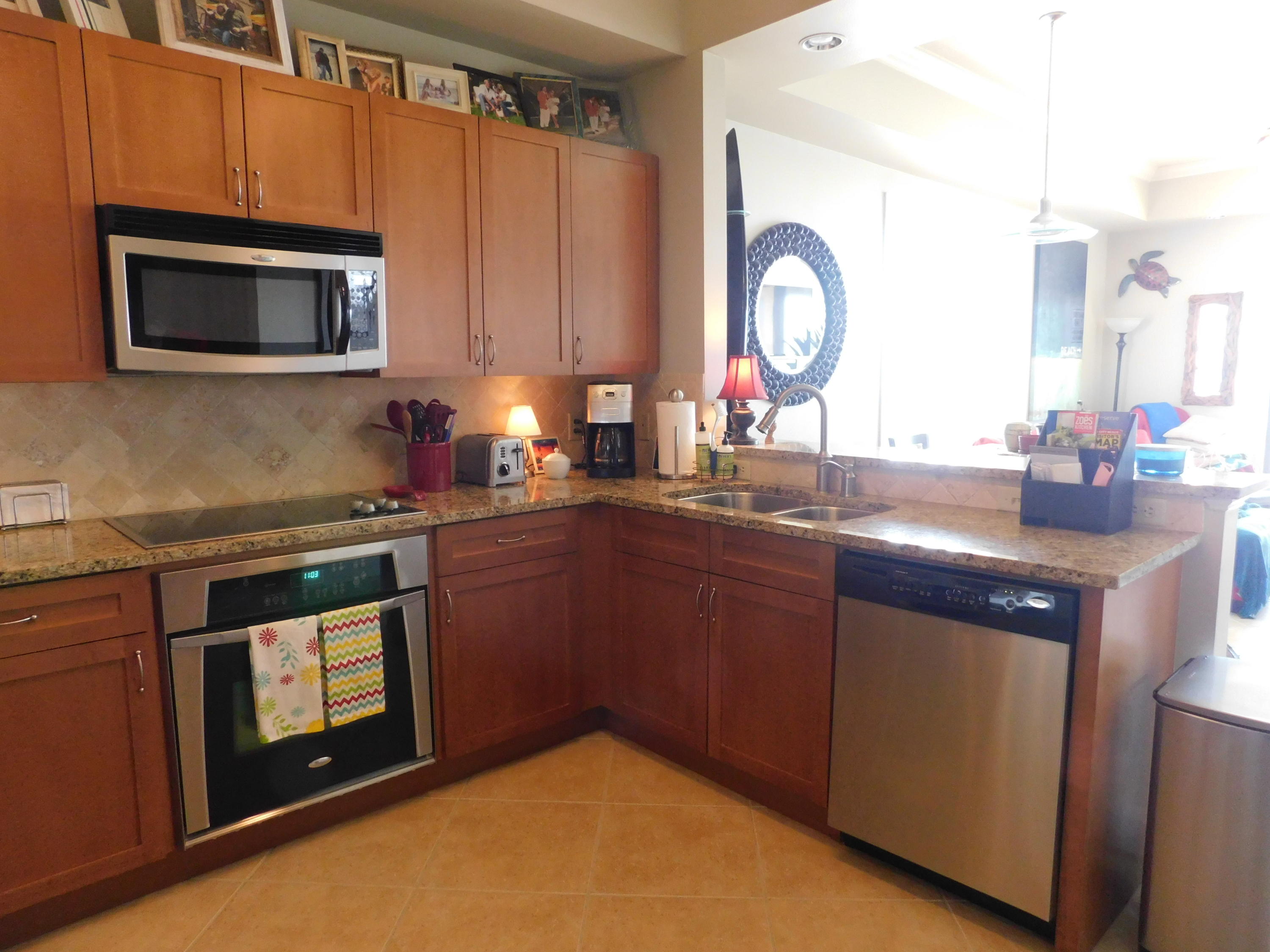 4368 West County Highway 30A, Unit 401 Santa Rosa Beach, FL 32459 - Photo 7 of 22 a kitchen with stainless steel appliances granite countertop a stove a sink and a microwave