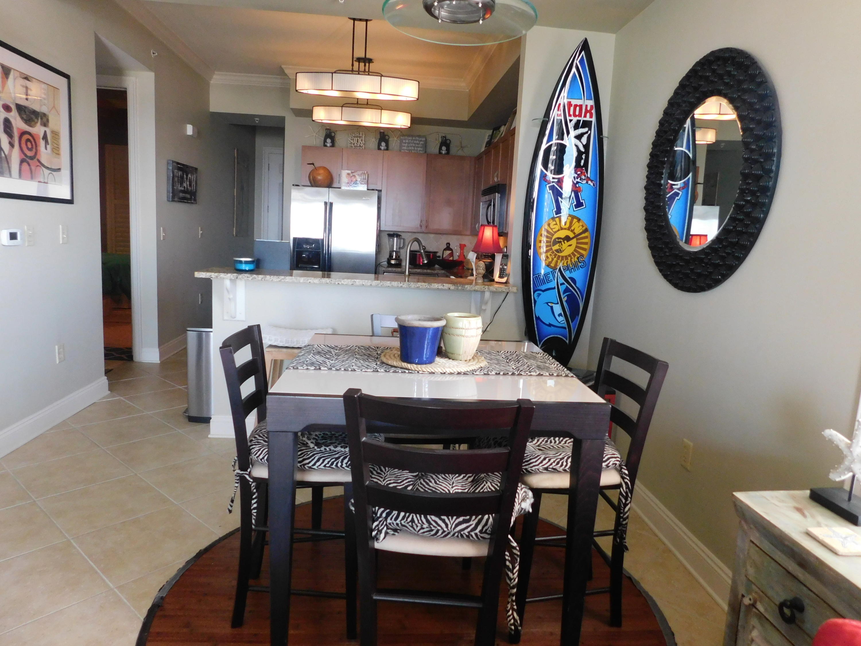4368 West County Highway 30A, Unit 401 Santa Rosa Beach, FL 32459 - Photo 8 of 22 a view of a dining room with furniture and a chandelier