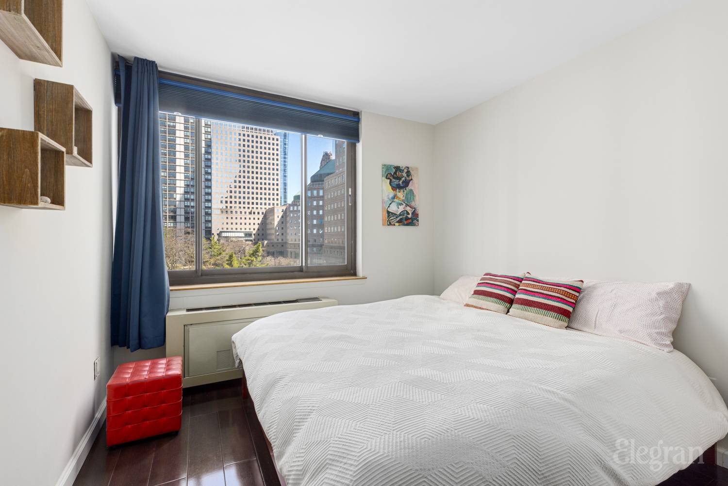 300 Albany Street, Unit 7I Manhattan, NY 10280 - Photo 2 of 9 a bedroom with a bed and wooden floor