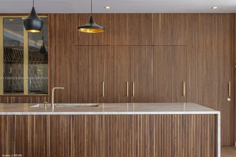 a kitchen with a sink a counter top space and stainless steel appliances