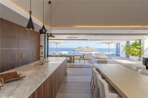 a dining room with wooden floor a glass table and chairs