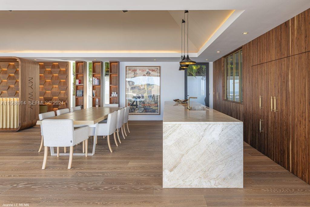 Source Colombier, SA 00000 - Photo 13 of 40 a dining room with wooden floor a glass table and chairs