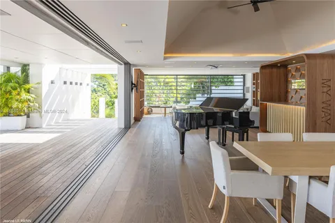 a living room with furniture a window and stainless steel appliances