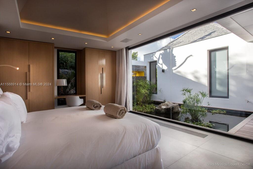 Source Colombier, SA 00000 - Photo 25 of 40 a large bedroom with a large bed and large windows