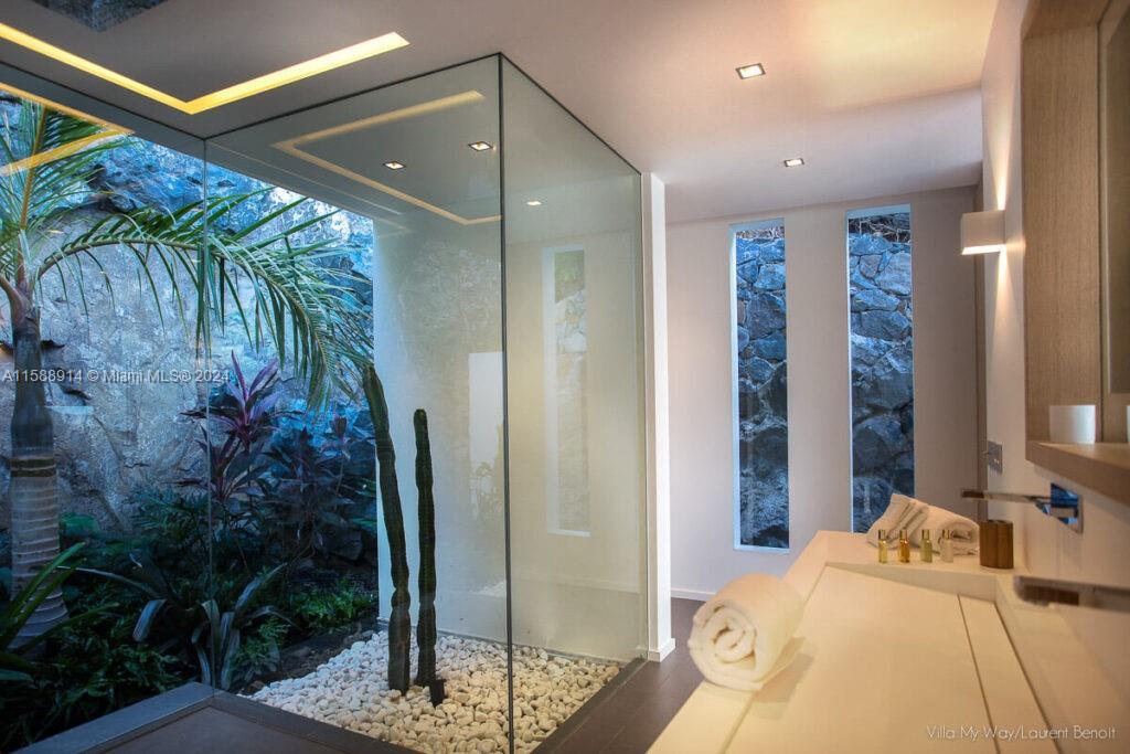 Source Colombier, SA 00000 - Photo 29 of 40 a bedroom with a bed and a potted plant