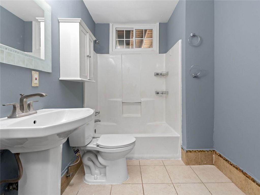 164 4th Street Northeast, Unit 9 Atlanta, GA 30308 - Photo 12 of 18 a bathroom with a sink toilet and shower