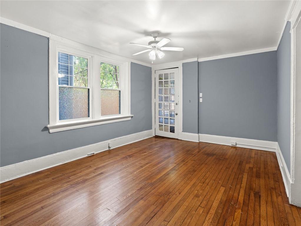 164 4th Street Northeast, Unit 9 Atlanta, GA 30308 - Photo 3 of 18 a view of an empty room with wooden floor and a window