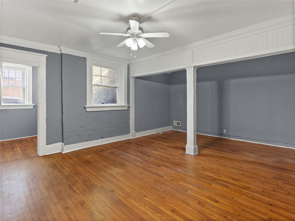 164 4th Street Northeast, Unit 9 Atlanta, GA 30308 - Photo 4 of 18 a view of an empty room with wooden floor and a window
