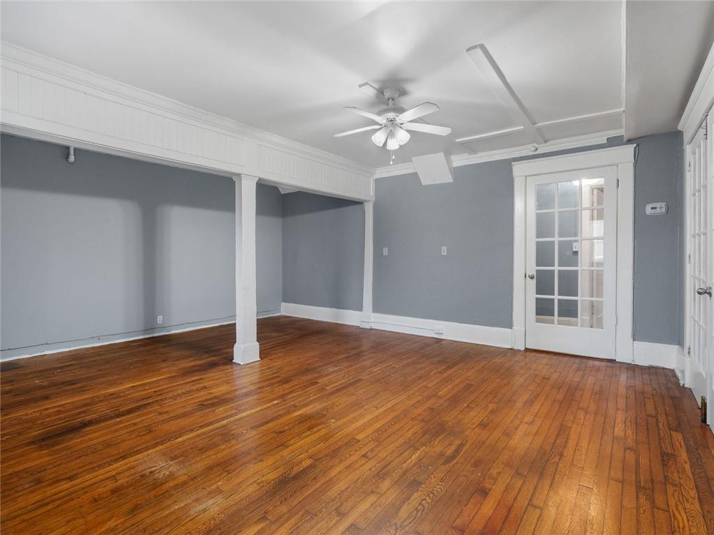 164 4th Street Northeast, Unit 9 Atlanta, GA 30308 - Photo 5 of 18 a view of an empty room with wooden floor and a ceiling fan