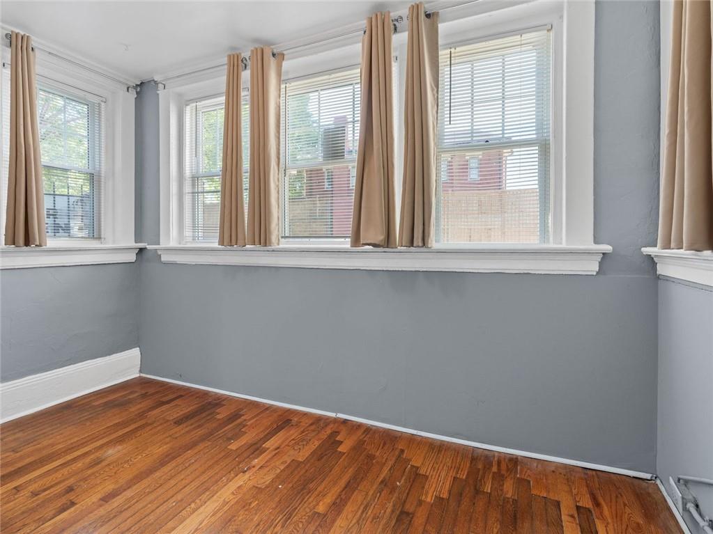164 4th Street Northeast, Unit 9 Atlanta, GA 30308 - Photo 6 of 18 a view of a room with wooden floor and fan