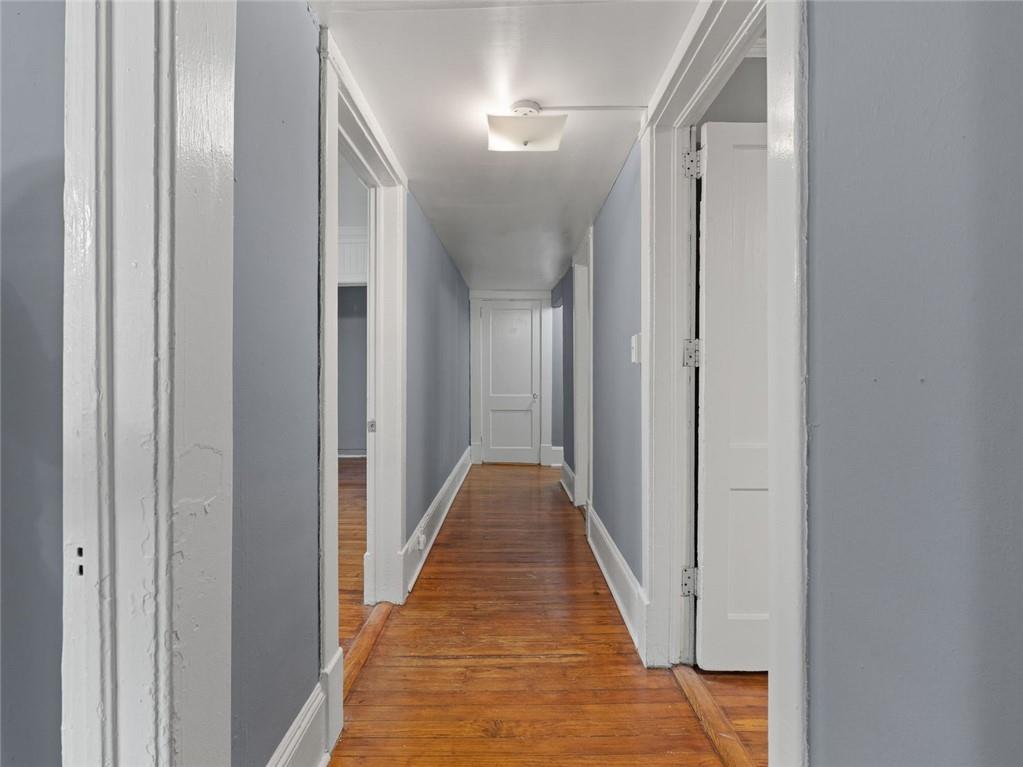 164 4th Street Northeast, Unit 9 Atlanta, GA 30308 - Photo 7 of 18 a view of a hallway with wooden floor and closet