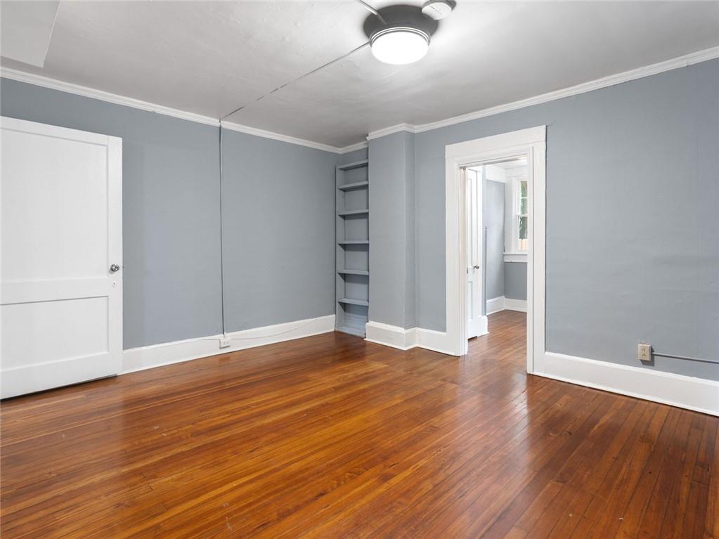 164 4th Street Northeast, Unit 9 Atlanta, GA 30308 - Photo 9 of 18 a view of an empty room with wooden floor