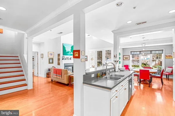 a kitchen that has a lot of cabinets and wooden floor
