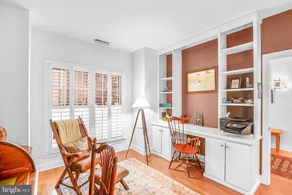 a view of a workspace with furniture and a window