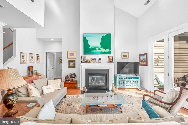 a living room with furniture a fireplace and a large window