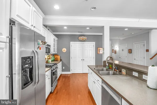 a kitchen with stainless steel appliances granite countertop a refrigerator and a sink