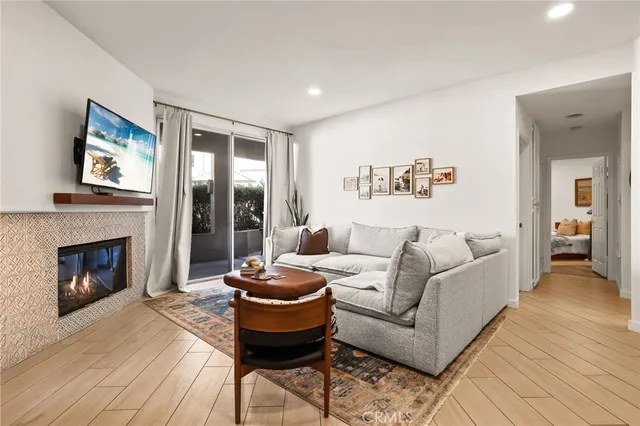 a living room with furniture a fireplace and a flat screen tv