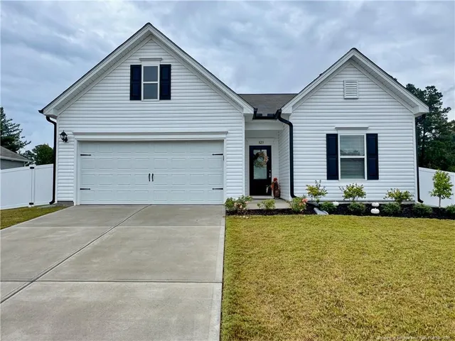 a view of a house with patio and a yard