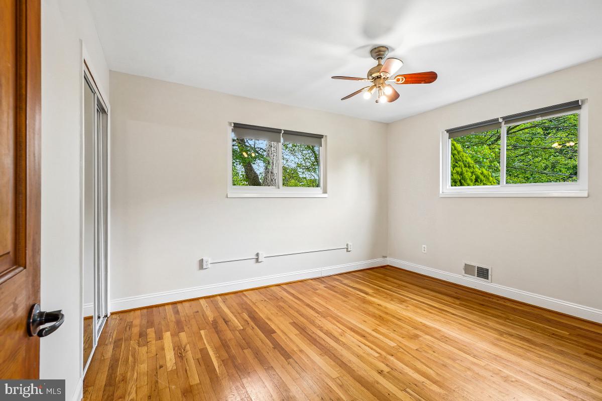 827 Caddington Avenue Silver Spring, MD 20901 - Photo 25 of 45 an empty room with a window and ceiling fan