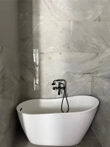 a white bath tub sitting in a bathroom