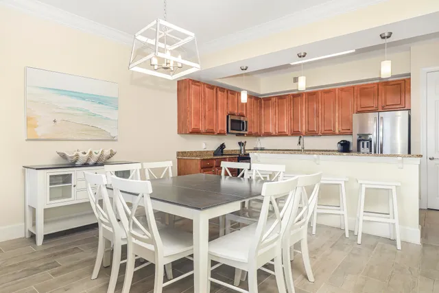 a kitchen with a dining table chairs and microwave