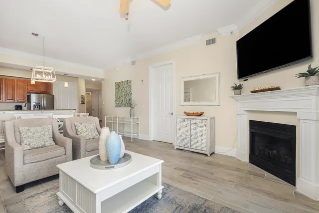 a living room with furniture a flat screen tv and a fireplace