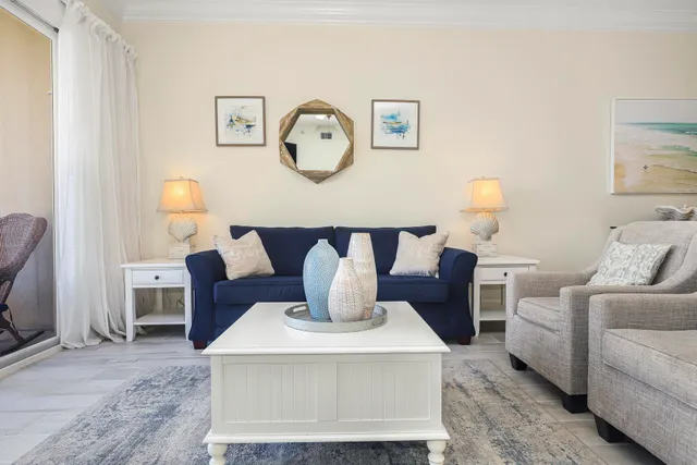 a living room with furniture a clock and wall