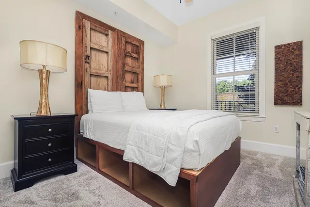 a kitchen with stainless steel appliances granite countertop a table chairs and a refrigerator