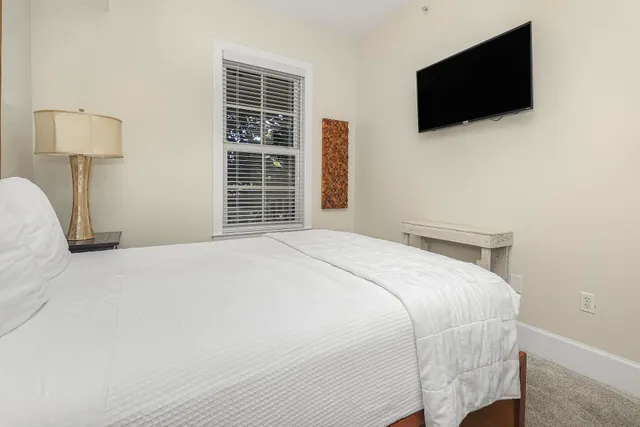 a bedroom with a bed and a lamp