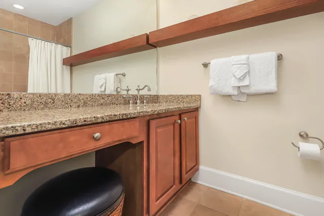 a bedroom with a bed and a mirror