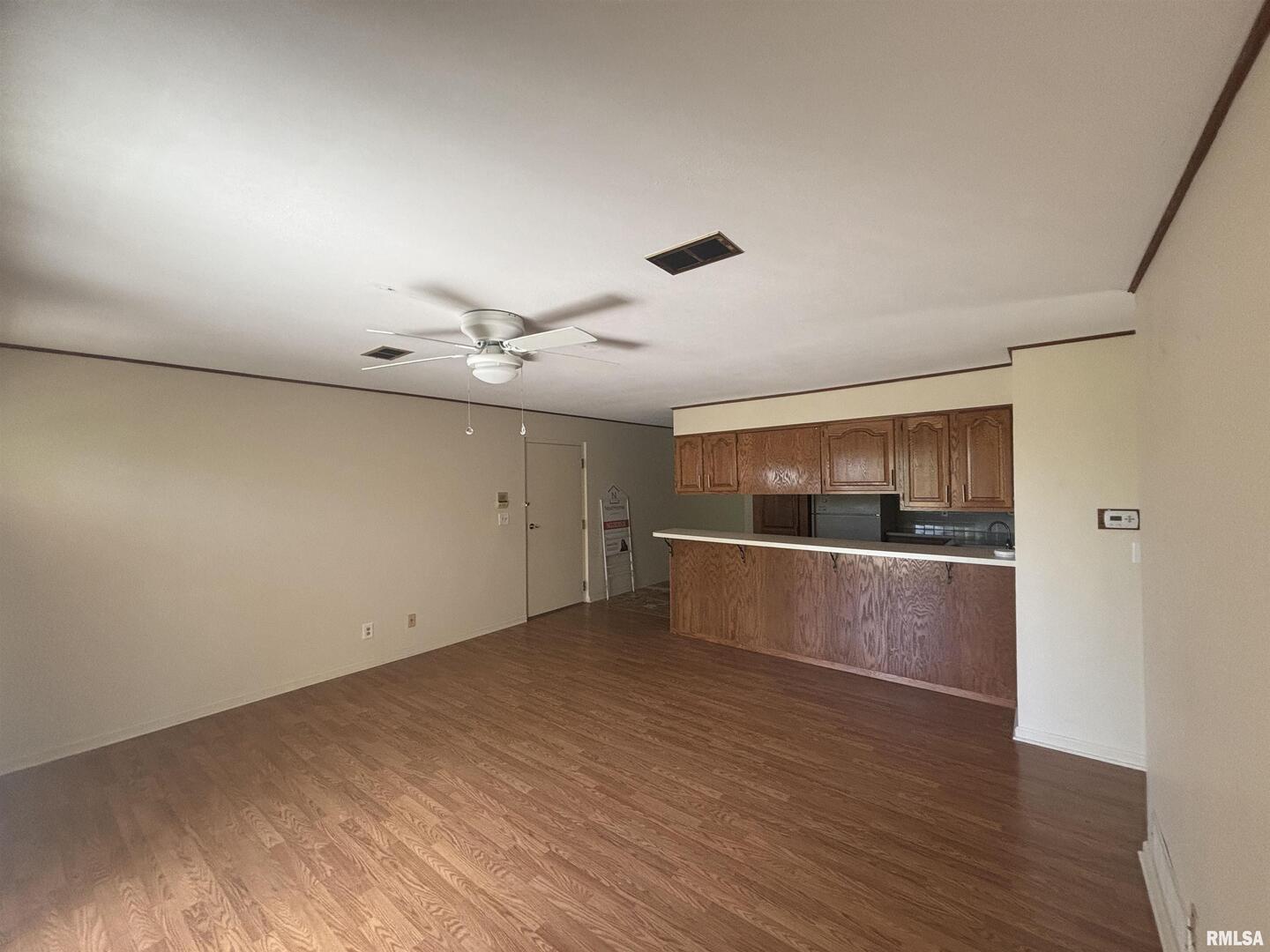 920 17th Street, Unit 28 Moline, IL 61265 - Photo 9 of 17 an empty room with wooden floor and windows