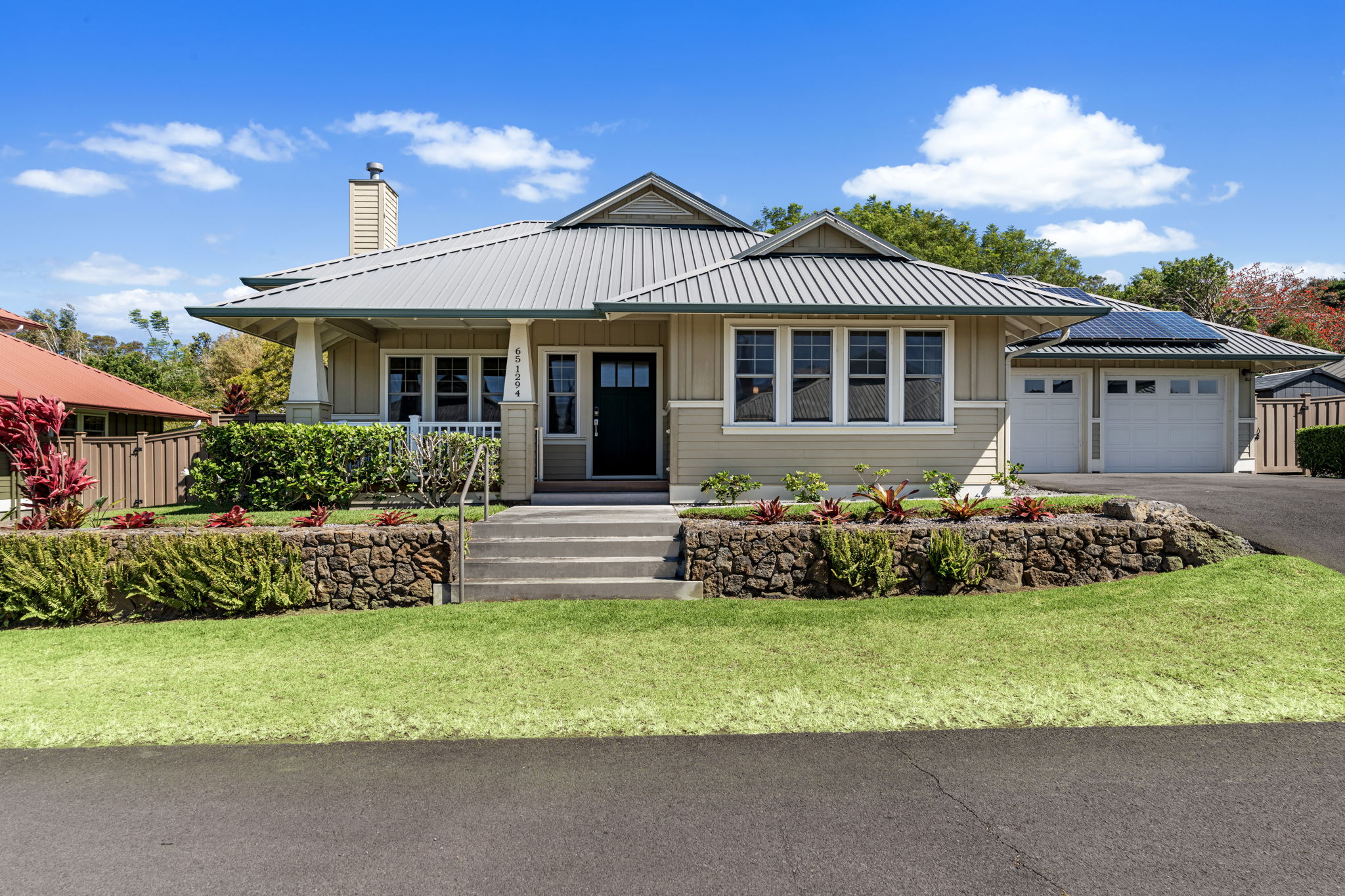 a front view of a house with a garden
