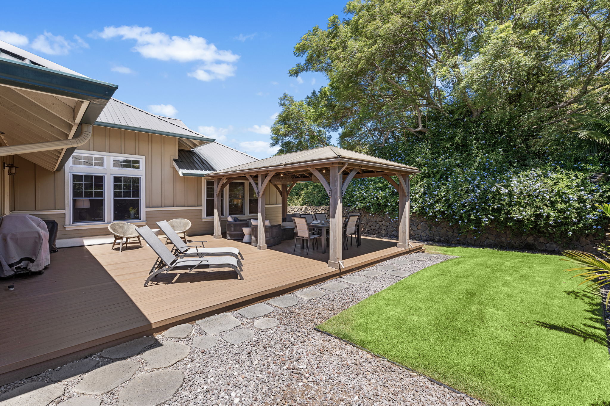 65-1294 Hoku Road Kamuela, HI 96743 - Photo 22 of 30 a view of a patio with couches table and chairs under an umbrella with a barbeque