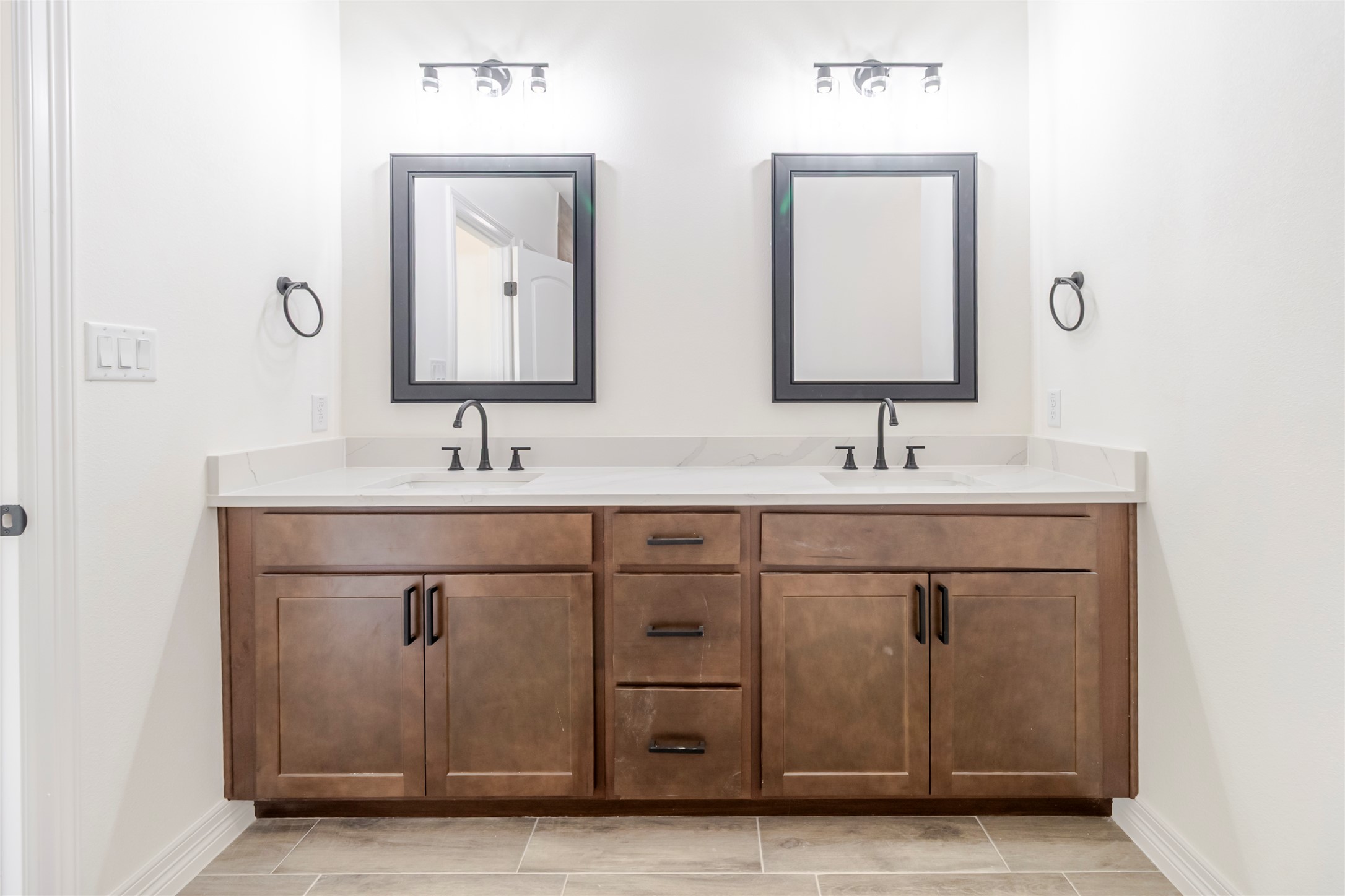 311 Myrtle Road Smithville, TX 78957 - Photo 9 of 16 A dual quartz vanity means the morning routine doesn’t require negotiations.