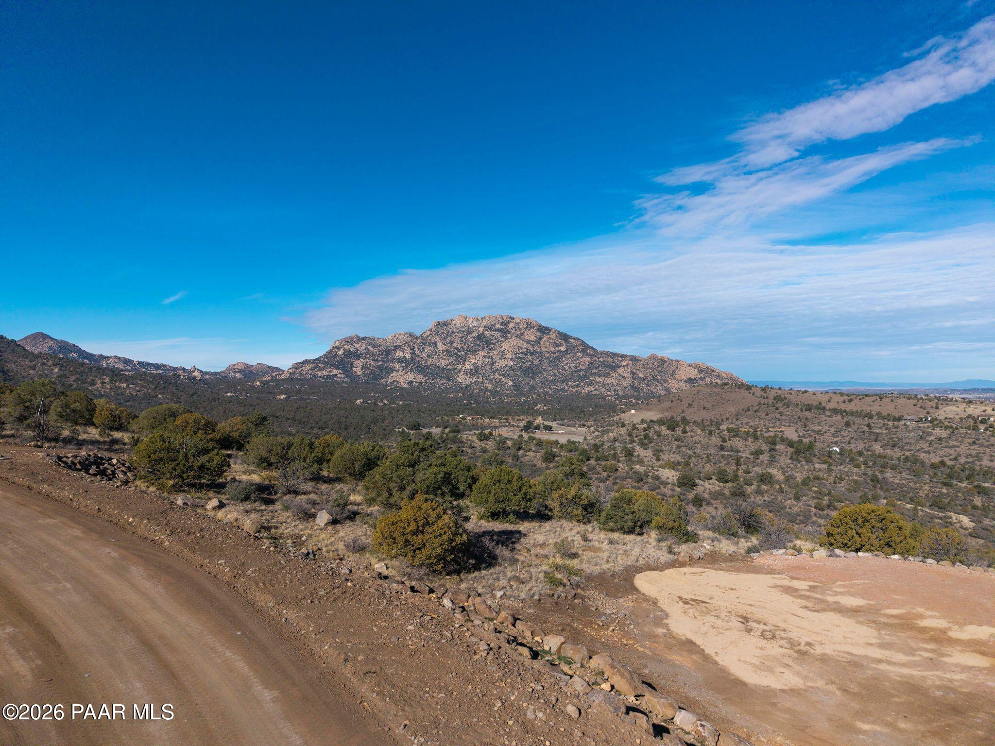 a view of a road with mountains in the background