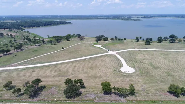 an aerial view of a houses with a yard