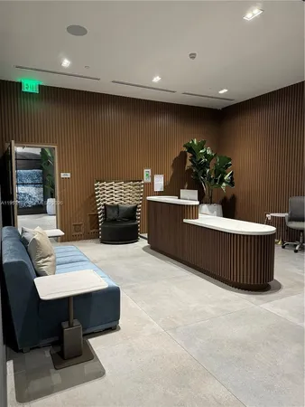 a living room with furniture a potted plant and a fireplace